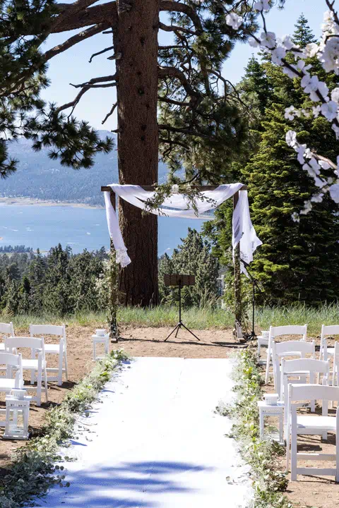 Wedding ceremony set up at the top of the mountain with big bear lake in the background